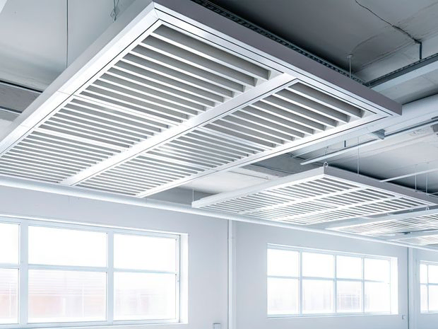 Metal slat frame on white ceiling, used for air ventilation.